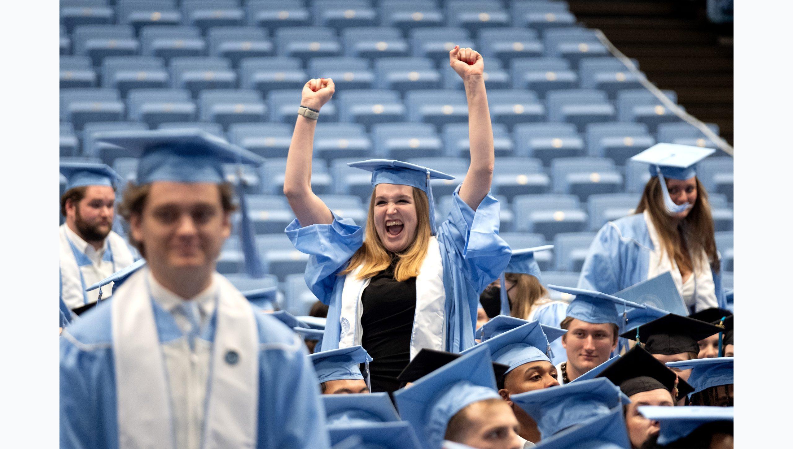 A graduate excitedly pumping her fists at U.N.C. Chapel Hill's Winter Commencement.